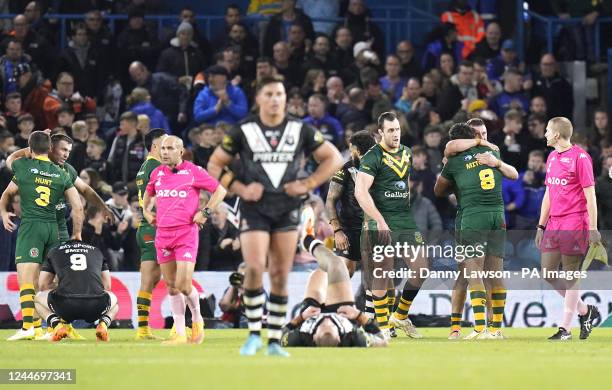 Australia players celebrate as New Zealand players loo dejected after the final whistle the Rugby League World Cup semi-final match at Elland Road,...