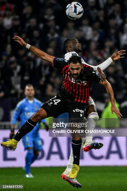 Lyon's Ivorian defender Sinaly Diomande heads the ball with Nice's French forward Gaetan Laborde during the French L1 football match between...
