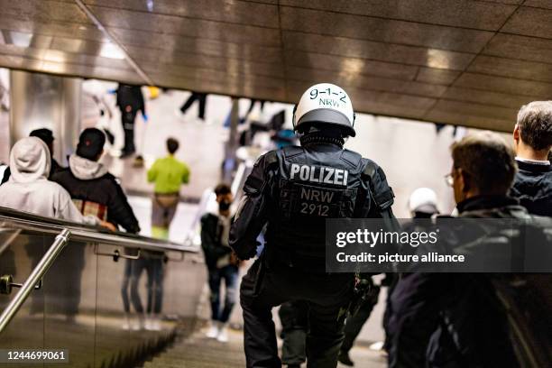 November 2022, North Rhine-Westphalia, Duesseldorf: Police officers in full gear with hard hats check in the old town at the beginning of the new...