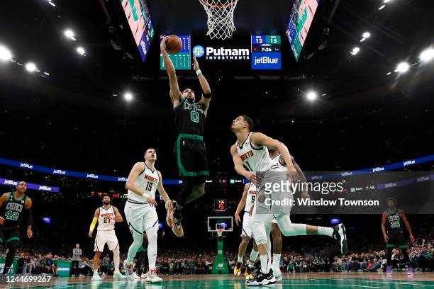 Jayson Tatum of the Boston Celtics goes to the basket past Michael Porter Jr. #1 of the Denver Nuggets during the second quarter at TD Garden on...