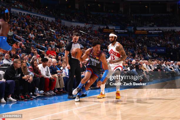 Aaron Wiggins of the Oklahoma City Thunder handles the ball during the game against the Toronto Raptors on November 11, 2022 at Paycom Arena in...