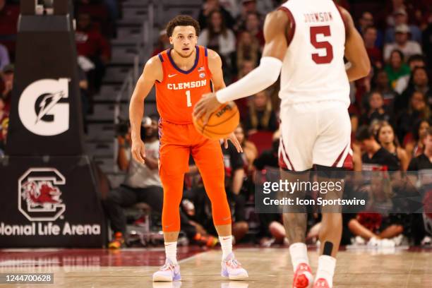 Chase Hunter of the Clemson Tigers defends Meechie Johnson of the South Carolina Gamecocks as he brings the ball down the court during a basketball...