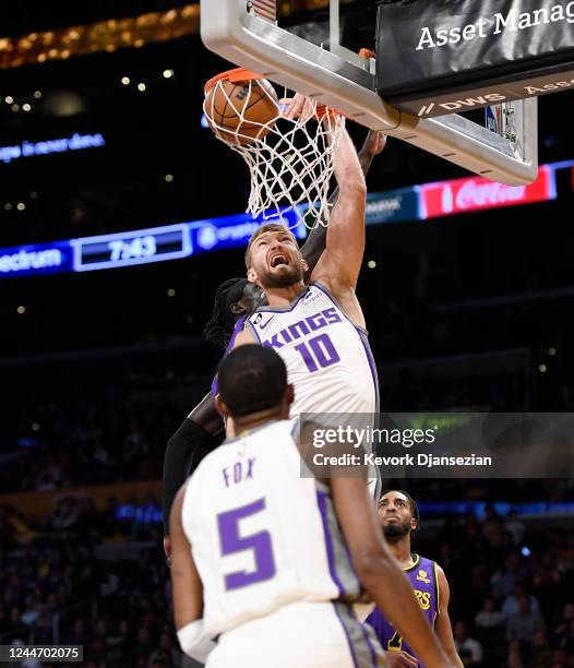 Domantas Sabonis of the Sacramento Kings dunks the ball against Wenyen Gabriel of the Los Angeles Lakers during the first half at Crypto.com Arena on...