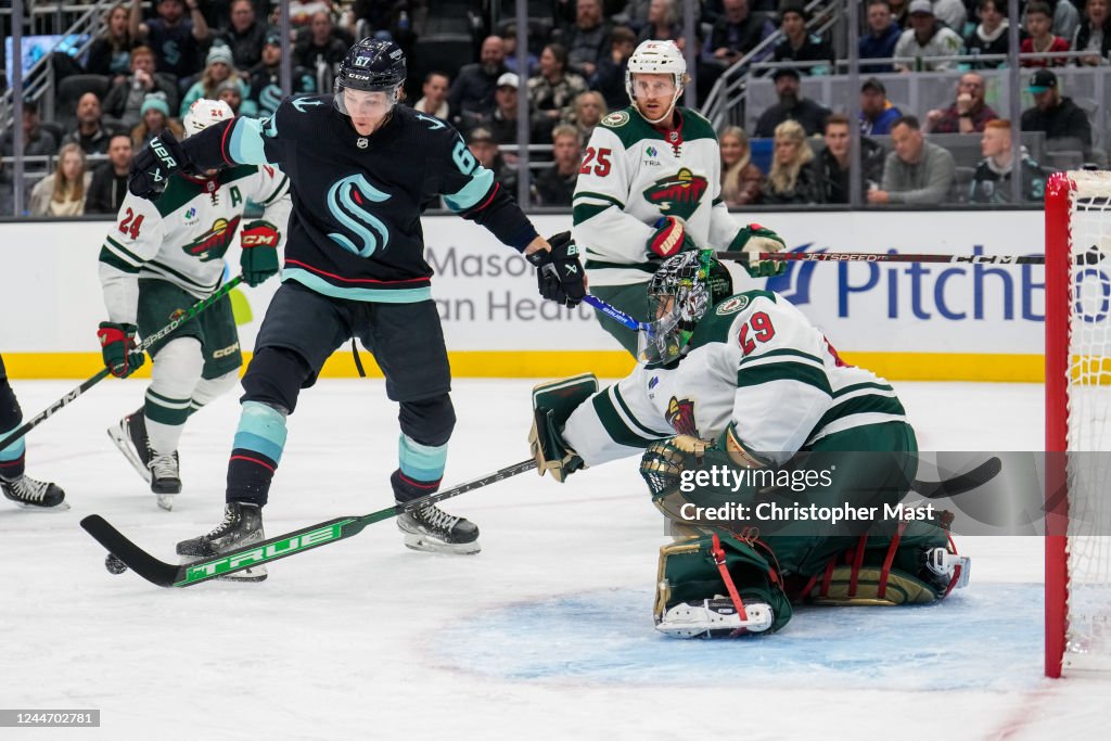 MarcAndre Fleury of the Minnesota Wild knocks the puck away from the