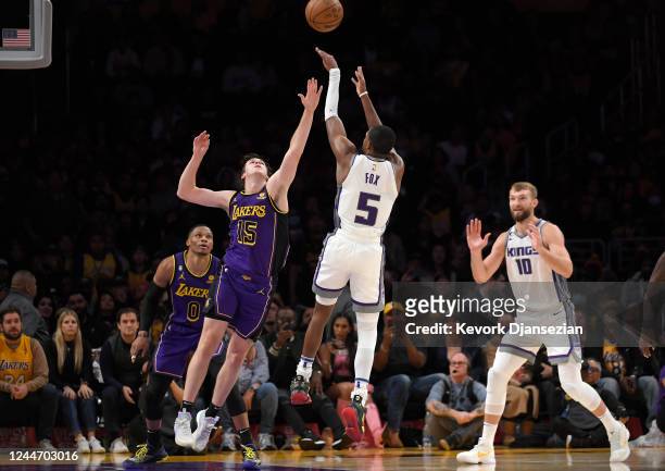 De'Aaron Fox of the Sacramento Kings scores a three-point basket late in the game against Austin Reaves of the Los Angeles Lakers at Crypto.com Arena...