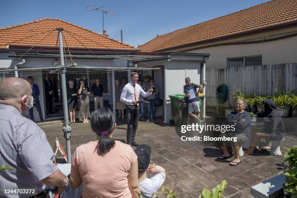 An auctioneer, center, speaks to attendees at a residential home auction in the Maroubra area in Sydney, Australia, on Saturday, Nov. 12, 2022....