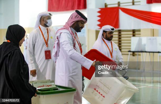 Bahraini poll clerks prepare ballot boxes at a polling station on the island of Muharraq, north of the capital Manama, during parliamentary...