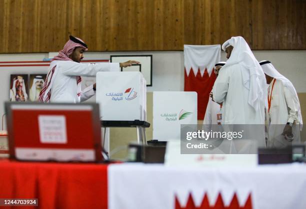 Bahraini poll clerks prepare ballot boxes at a polling station on the island of Muharraq, north of the capital Manama, during parliamentary...