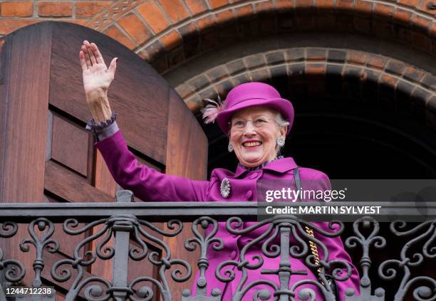 Denmark's Queen Margrethe II waves to onlookers from the balcony of Copenhagen City Hall prior to celebrations of the Queen's 50-year reign, in...