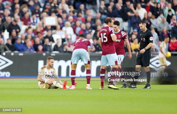 Nayef Aguerd of West Ham United checks on James Maddison of Leicester City as he awaits treatment before going off injured during the Premier League...