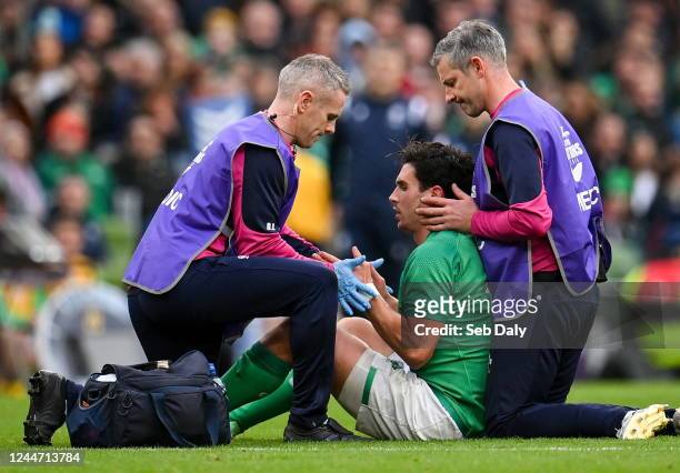 Dublin , Ireland - 12 November 2022; Joey Carbery of Ireland receives medical attention team doctor Ciaran Cosgrave, left, and team chartered...