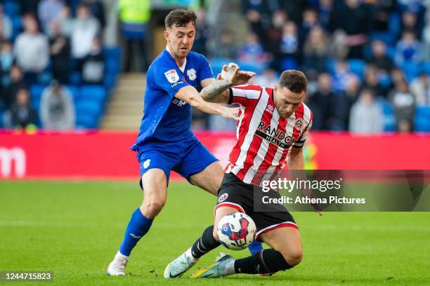 Ryan Wintle of Cardiff City fouls Billy Sharp of Sheffield United during the Sky Bet Championship match between Cardiff City and Sheffield United at...