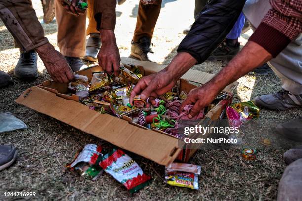 People after attending the rally of Ghulam Nabi Azad collect their Cigarette, Khani, Naswar and other tobacco packets which they deposited before...