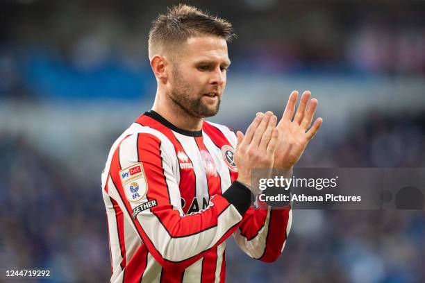 Oliver Norwood of Sheffield United applauds the supporters during the Sky Bet Championship match between Cardiff City and Sheffield United at the...