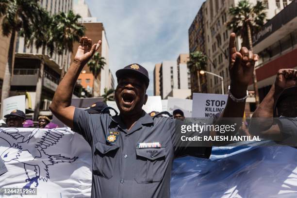 Police officers march during the Mens Walk For Change where hundreds of men and women from the South African Police Services and gender based...