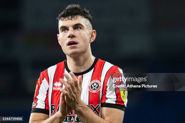 John Egan of Sheffield United applauds the supporters during the Sky Bet Championship match between Cardiff City and Sheffield United at the Cardiff...