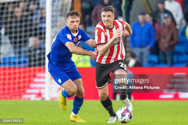 Mark Harris of Cardiff City fouls Ciaran Clark of Sheffield United during the Sky Bet Championship match between Cardiff City and Sheffield United at...