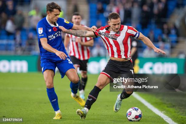 Perry Ng of Cardiff City fouls Billy Sharp of Sheffield United during the Sky Bet Championship match between Cardiff City and Sheffield United at the...