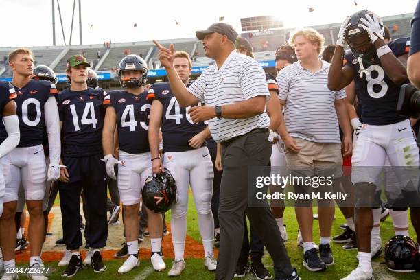 Head coach Tony Elliott of the Virginia Cavaliers leads his team off the field after a game against the Pittsburgh Panthers at Scott Stadium on...