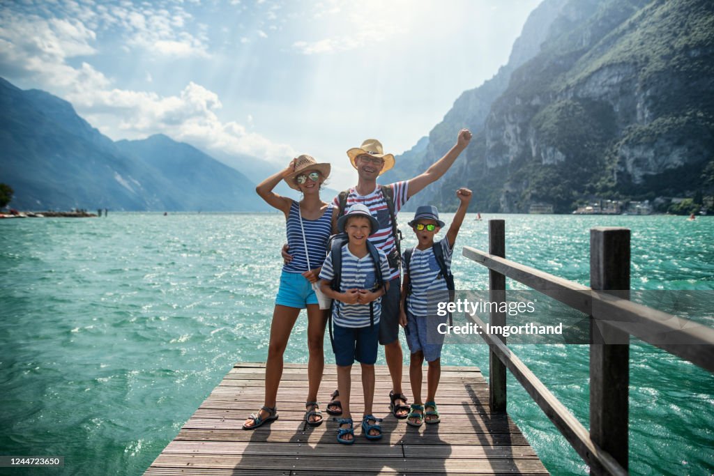 Family standing on pier and enjoying view of Lake Garda