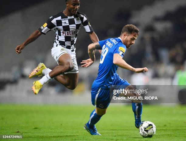 Porto's Spanish forward Toni Martinez is challenged by Boavista's Nigerian defender Bruno Onyemaechi during the Portuguese league football match...