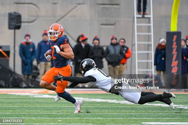 Illinois Fighting Illini running back Chase Brown avoids the diving tackle attempt of Purdue Boilermakers cornerback Bryce Hampton during a Big 10...