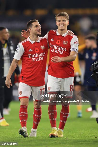 Cedric Soares and Martin Odegaard of Arsenal celebrate victory during the Premier League match between Wolverhampton Wanderers and Arsenal FC at...