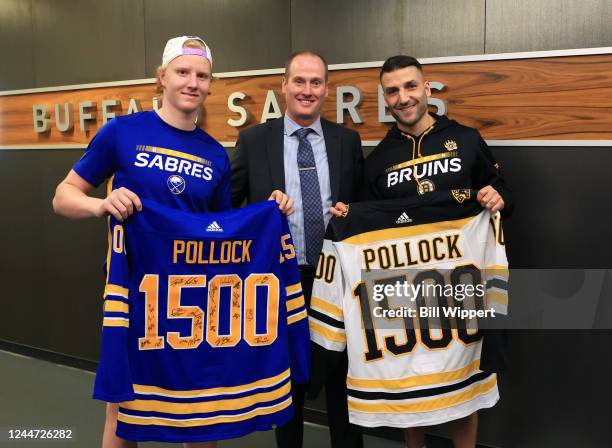 Referee Kevin Pollock receives signed jerseys from Rasmus Dahlin of the Buffalo Sabres and Patrice Bergeron of the Boston Bruins prior to working his...