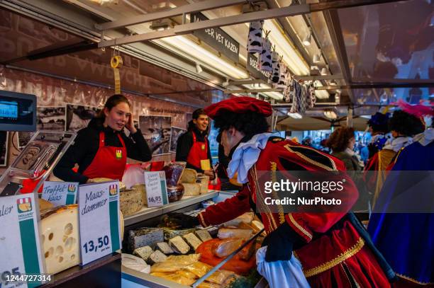 St Nicholas helpers without blackface are giving the traditional cookies called Pepernoten, during the arrival of the red-and-white-clad Sinterklaas...