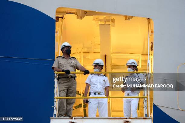 This picture taken on November 12 shows the crew of The Majestic Princess cruise ship preparing to depart for Melbourne from the International...