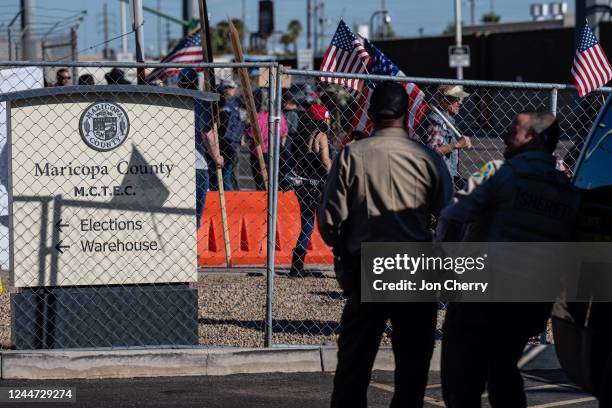 Right wing activists gather on the sidewalk in protest of the election process in front of the Maricopa County Tabulation and Election Center on...