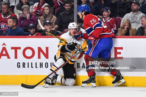 Johnathan Kovacevic of the Montreal Canadiens keeps Kasperi Kapanen of the Pittsburgh Penguins against the boards during the first period of the game...