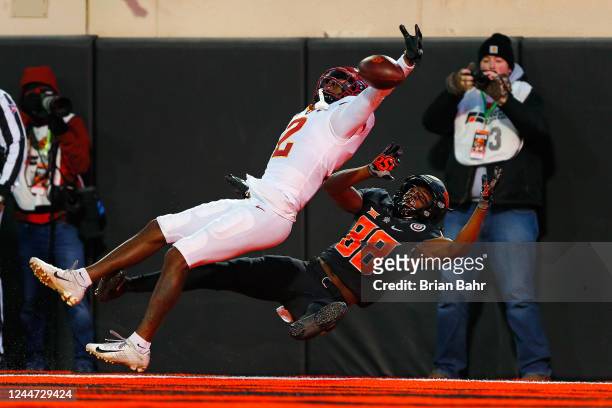 Defensive back T.J. Tampa of the Iowa State Cyclones blocks a touchdown pass as wide receiver Langston Anderson of the Oklahoma State Cowboys gets...