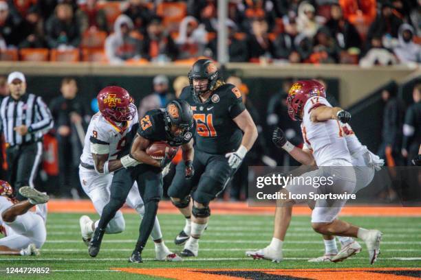 Oklahoma State Cowboys running back Jaden Nixon is tackled by Iowa State Cyclones defensive end Will McDonald IV on November 12th, 2022 at Boone...