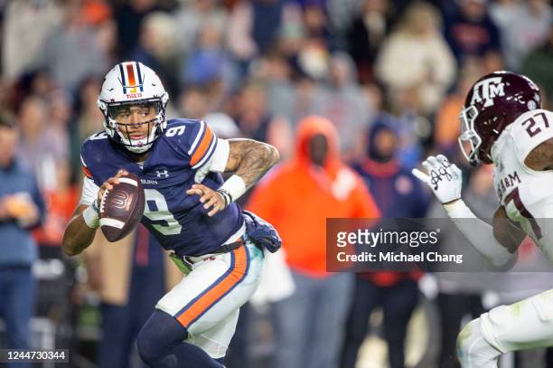 Quarterback Robby Ashford of the Auburn Tigers looks to maneuver the ball by defensive back Antonio Johnson of the Texas A&M Aggies during the first...