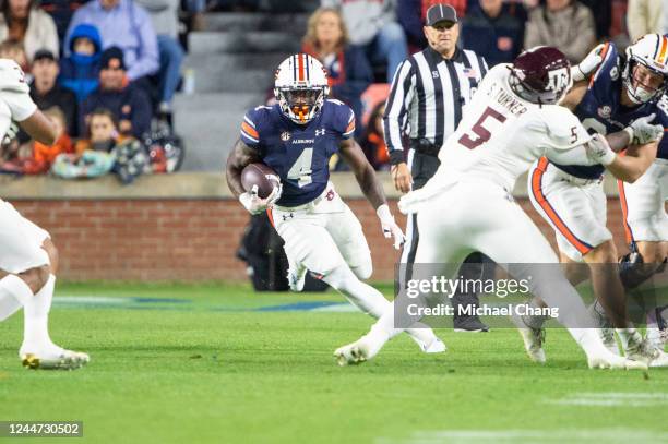 Running back Tank Bigsby of the Auburn Tigers looks to run the ball through traffic during the first half of their game against the Texas A&M Aggies...