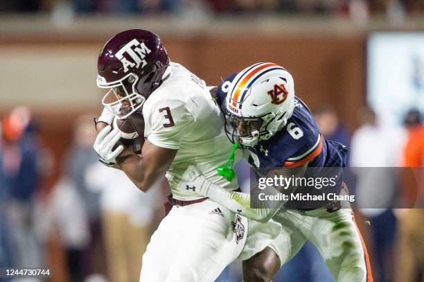 Cornerback Keionte Scott of the Auburn Tigers looks to tackle wide receiver Devin Price of the Texas A&M Aggies during the first half of play at...