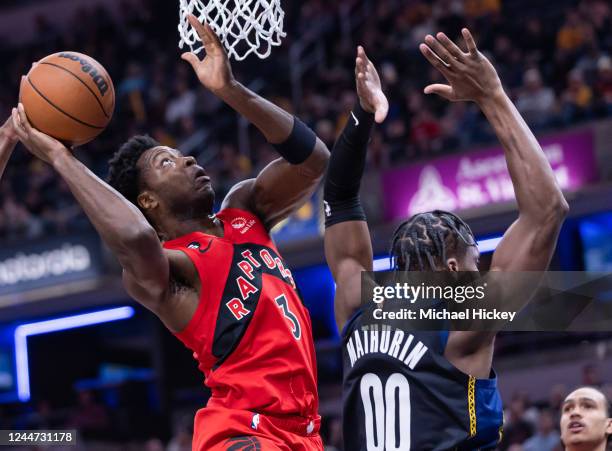 Anunoby of the Toronto Raptors shoots the ball against Bennedict Mathurin of the Indiana Pacers during the first half of the game at Gainbridge...