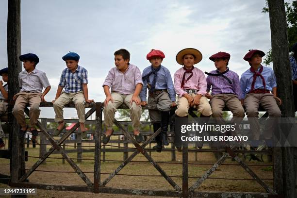 Gaucho kids watch a rodeo exhibition during the 83rd Tradition Festival in San Antonio de Areco, Argentina, on November 12, 2022. The celebration...