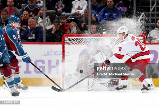 Sebastian Aho of the Carolina Hurricanes vies for a loose puck against Cale Makar of the Colorado Avalanche at Ball Arena on November 12, 2022 in...