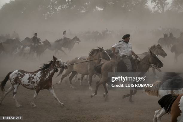 Gauchos ride their horses during the 83rd Tradition Festival in San Antonio de Areco, Argentina, on November 12, 2022. - Riders in berets,...