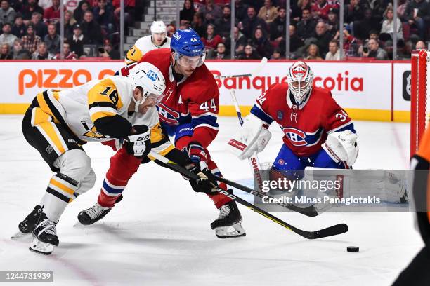 Jason Zucker of the Pittsburgh Penguins and Joel Edmundson of the Montreal Canadiens battle for the puck during the third period of the game at...