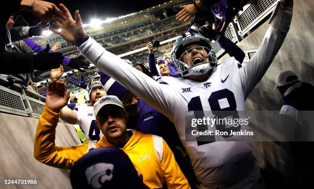 Will Howard of the Kansas State Wildcats celebrates with fans following the teams 31-3 win over the Baylor Bears at McLane Stadium on November 12,...