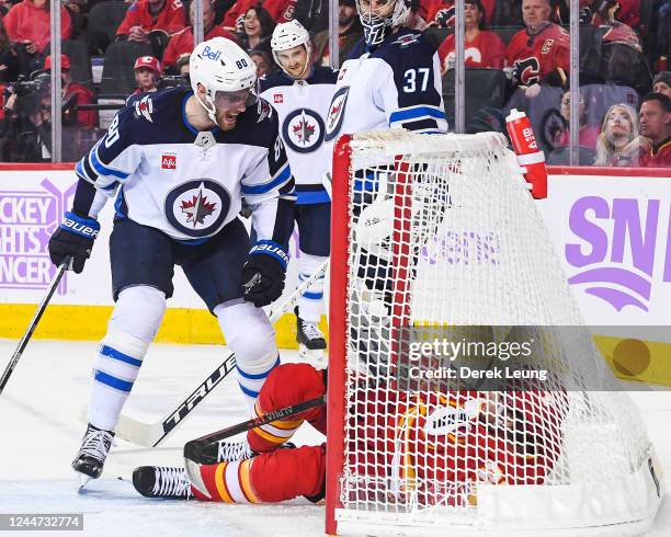 Blake Coleman of the Calgary Flames and Pierre-Luc Dubois of the Winnipeg Jets exchange words during the first period of an NHL game at Scotiabank...