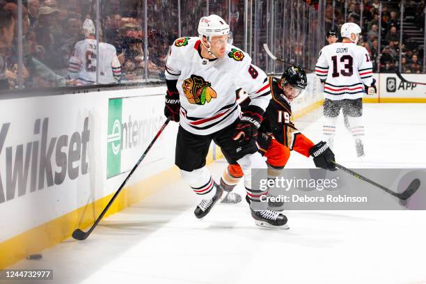 Jack Johnson of the Chicago Blackhawks and Troy Terry of the Anaheim Ducks battle for the puck during the first period of the game at Honda Center on...