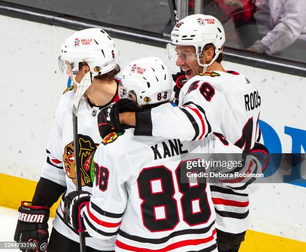 Filip Roos of the Chicago Blackhawks celebrates his second-period goal with Patrick Kane and Jake McCabe during the game against the Anaheim Ducks at...