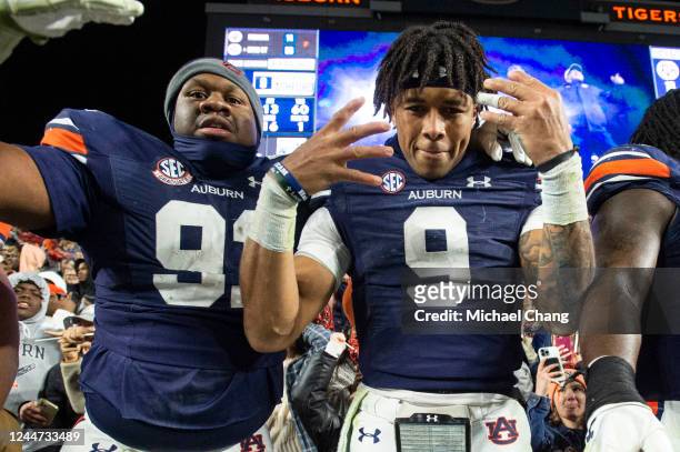 Defensive lineman Morris Joseph Jr. #91 of the Auburn Tigers and quarterback Robby Ashford of the Auburn Tigers celebrate after defeating the Texas...