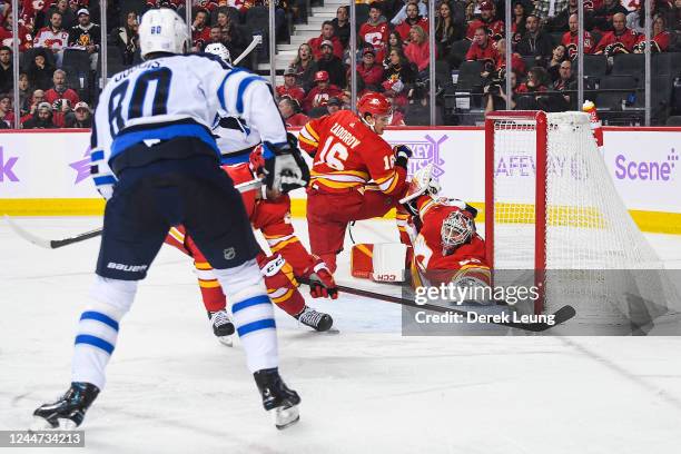 Pierre-Luc Dubois of the Winnipeg Jets scores against Jacob Markstrom of the Calgary Flames during the second period of an NHL game at Scotiabank...