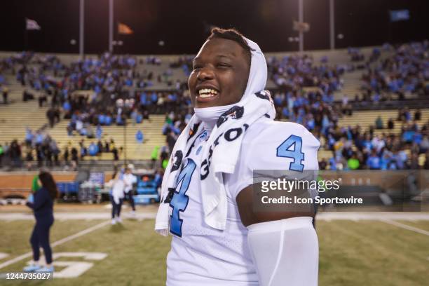 Travis Shaw of the North Carolina Tar Heels smiles as he walks off of the field after a football game between the Wake Forest Demon Deacons and the...