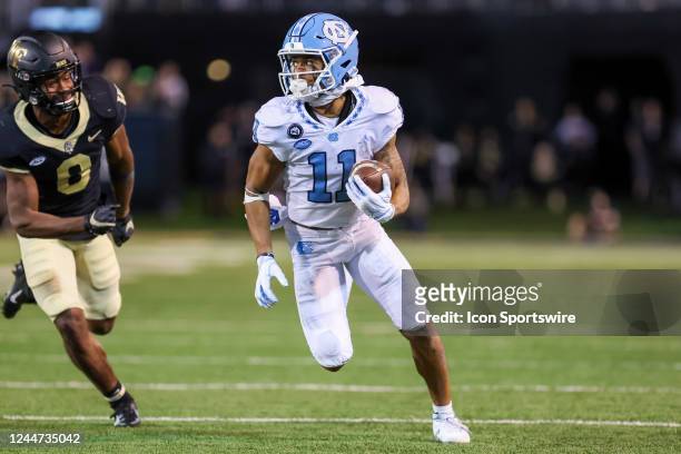 Josh Downs of the North Carolina Tar Heels runs the ball after making a catch during a football game between the Wake Forest Demon Deacons and the...